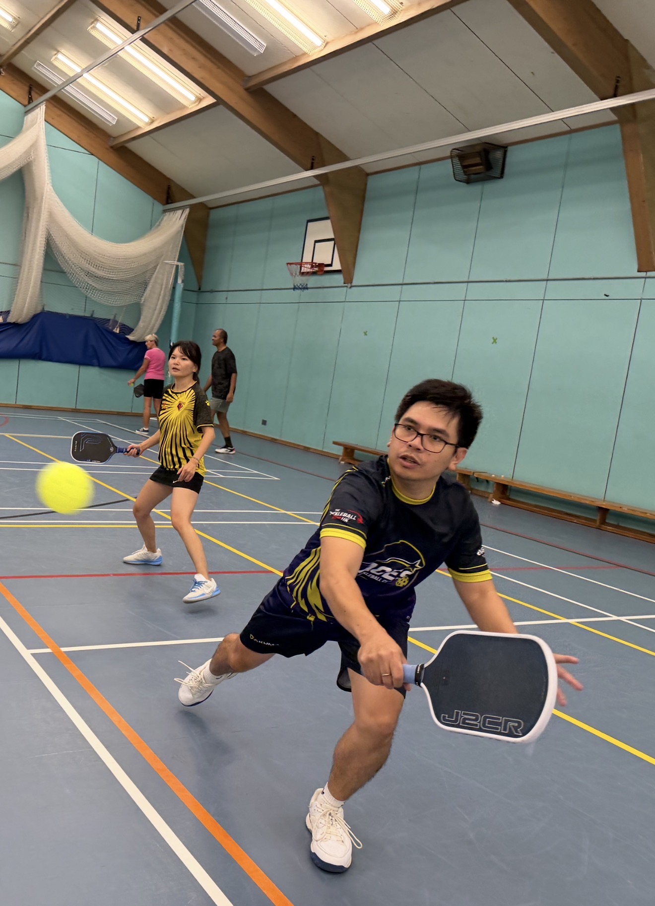 Aces pickleball player reaching for a shot